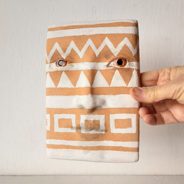 Terracotta orange and white wall mask sculpture with diamond pattern, ceramic face art, tribal style art lover gift