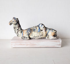 Desert camel with sandy colours, ceramic sculpture on timber mount, Sahara nomad art