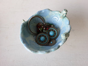 Pale blue bowl with quirky naked male in a spiral water pattern surface, curly footed jewellery organiser dish