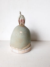 Male statue on mound with timber plinth, ceramic antique look sculpture with celadon green and red glaze