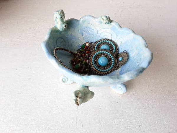 Pale blue bowl with quirky naked male in a spiral water pattern surface, curly footed jewellery organiser dish