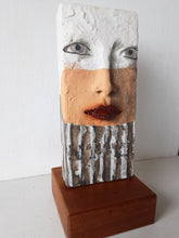 Modern sculpture head on timber plinth, ceramic female face in terracotta with black and white stripes