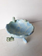 Pale blue bowl with quirky naked male in a spiral water pattern surface, curly footed jewellery organiser dish