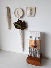 Modern sculpture head on timber plinth, ceramic female face in terracotta with black and white stripes