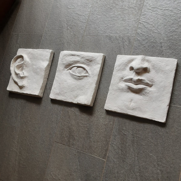 Large white art triptych, ceramic classic sculpture of face in three parts, hear no see no speak no evil