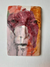 Pink and orange ceramic face sculpture, abstract wall art with multiple colors