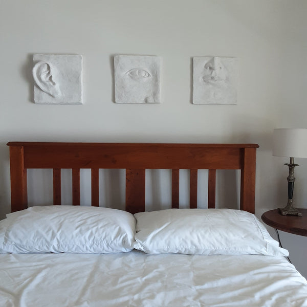 Large white art triptych, ceramic classic sculpture of face in three parts, hear no see no speak no evil