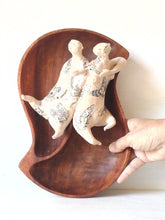 Tattoo wall art of two lovers entwined, sculpture, with reclaimed wood bowl and ceramic figures with butterfly tattoos