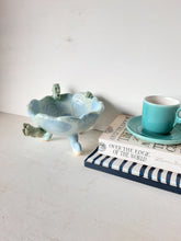 Pale blue bowl with quirky naked male in a spiral water pattern surface, curly footed jewellery organiser dish