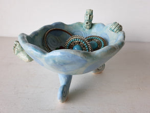 Pale blue bowl with quirky naked male in a spiral water pattern surface, curly footed jewellery organiser dish