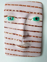 Pink and brown striped wall mask, ceramic sculpture of face