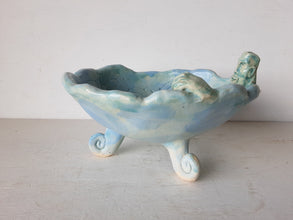 Pale blue bowl with quirky naked male in a spiral water pattern surface, curly footed jewellery organiser dish