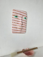 Pink and brown striped wall mask, ceramic sculpture of face