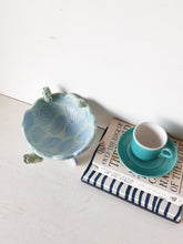 Pale blue bowl with quirky naked male in a spiral water pattern surface, curly footed jewellery organiser dish