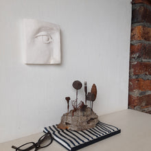 Rustic sculpture with seven recycled and ceramic objects on a timber plinth, coffee table art