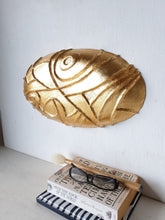 Gold ceramic wall sculpture carved into oval shape, Modernist luxe gilt wall decor