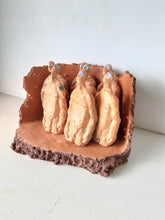 Male nude ceramic sculpture with seven figurines in terracotta on a rust colored curved plinth