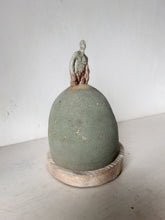 Male statue on mound with timber plinth, ceramic antique look sculpture with celadon green and red glaze